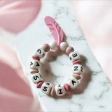 👶 Anneau de Dentition Plume Rose Personnalisé en Silicone Alimentaire