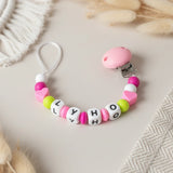 Attache tetine sans anneau  MAM personnalisé en perles de silicone couleurs anis, fushia et rose pour nouveau-né.