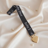 attache tétine baby dior de couleur noir 