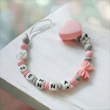 attache tétine en silicone rose blanche 