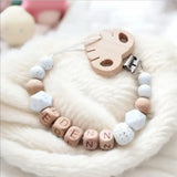 attache tétine en bois et silicone avec clips motif feuille