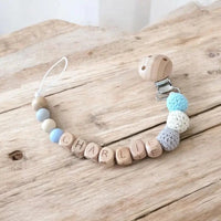 attache tétine en bois de couleur turquoise crème et gris 