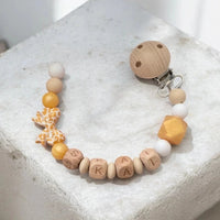 Attache tétine clip en silicone avec perles motif léopard,  perles dorées, un nœud élégant et un adaptateur pour tétine Mam.