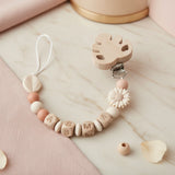 Attache tetine clip personnalisée avec clip en bois, perle marguerite crème, perle feuille et mélange de perles en silicone et bois naturel."