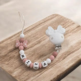 attache tétine bébé motif disney minnie de couleur blanche 