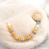 attache tetine motif léopard or 