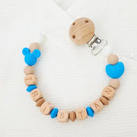 Attache tétine mickey artisanale avec perles en silicone bleu et perles en bois naturel, équipée d'un clip de fixation et d'un adaptateur Mam.
