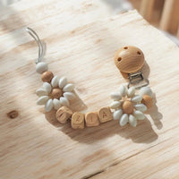 attache tétine mam en bois style marguerite en silicone 
