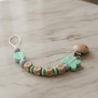 attache tetine mam clip silicone papillon menthe