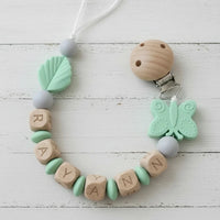attache tetine de couleur menthe papillon