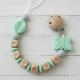 attache tetine de couleur menthe papillon