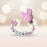 Attache tetine Minnie personnalisée en perles de silicone rose et blanc avec prénom pour bébé.