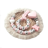 Attache tétine et son anneau de dentition assortis rose et blanc 