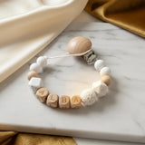 attache tétine en silicone en bois et blanc