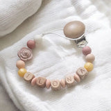 attache tétine en silicone et bois avec perle couleur or