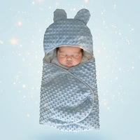 présentation d'une couverture emmaillotage minky bleu avec une bébé a l'interieur