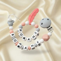 attache tétine en silicone et anneau de dentition de couleur peche