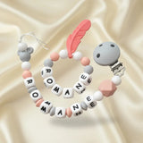attache tétine en silicone et anneau de dentition de couleur peche