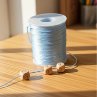 fil spécial attache tetine pour scelle le noeud en satin nylon de couleur bleu clair