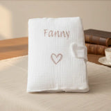 Protège carnet de santé personnalisé en gaze de coton blanc avec flocage du prénom de l'enfant."